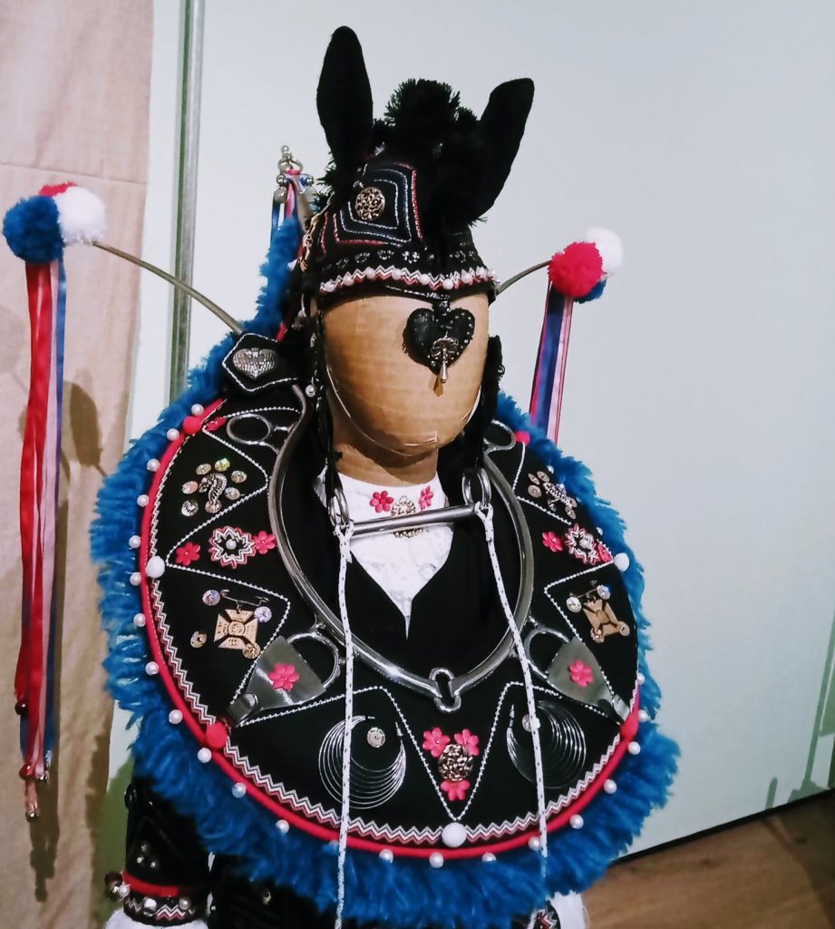 Mannequin dressed in embellished horse collar and hat from the Boy's Ploughing Match and The Festival of the Horse costume from the Orkney Islands