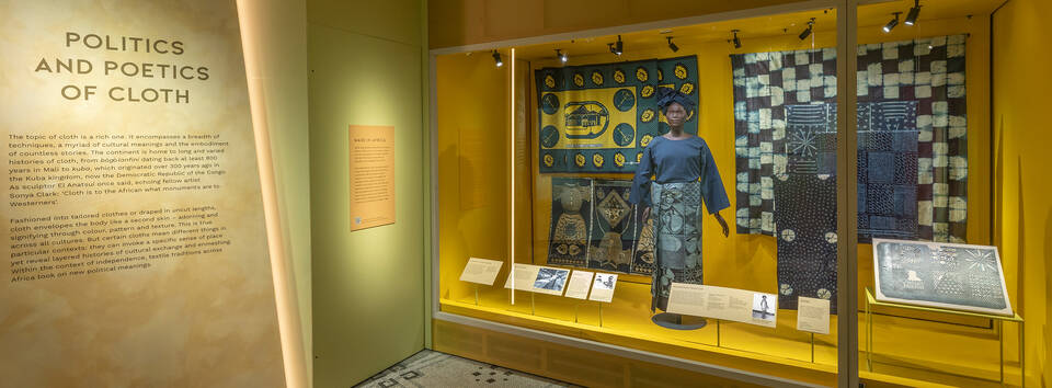 Display called 'Politics and Poetics of Cloth' showing a mannequin and range of cloths