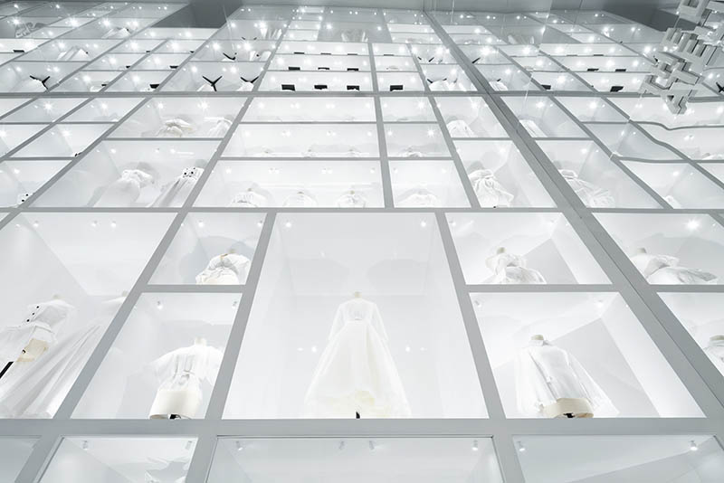 White haute couture dresses stacked high to a mirrored ceiling