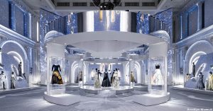 Display exhibiting many dresses in a silver gallery