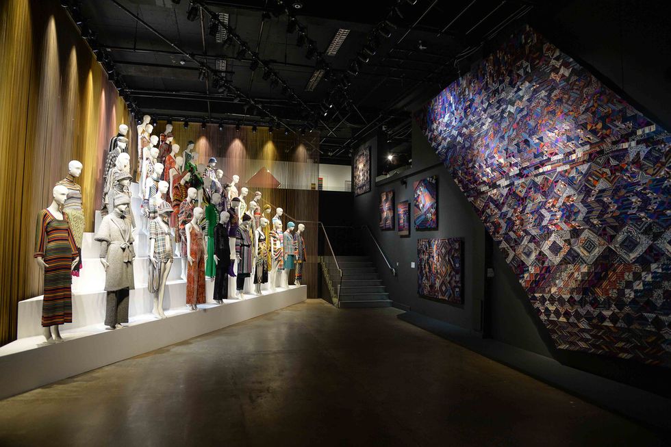 A selection of Missoni clothing displayed opposite a wall of textiles.