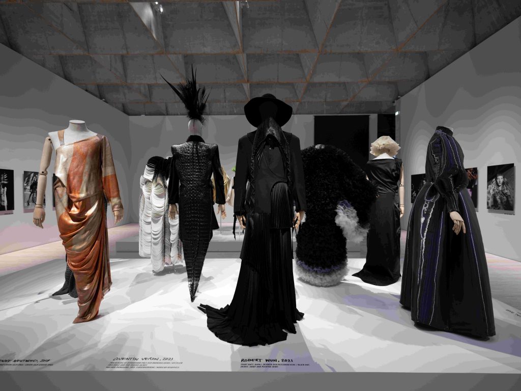 Three rows of dresses are displayed in a gallery.