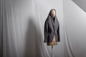 exhibition display of mannequin with grey jacket