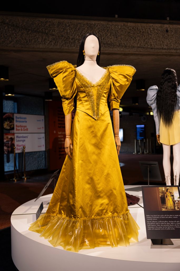 Yellow dress on mannequin with black wig.