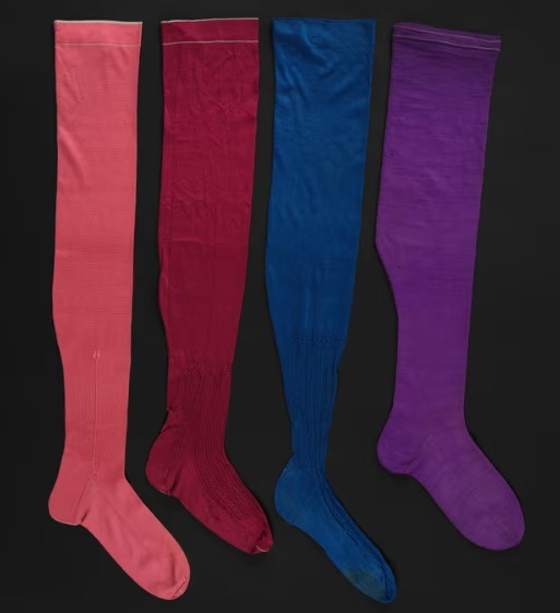 Ladies’ silk stockings, 1860s–80s. Photograph: Ellie Atkins/Fashion Museum, Bath. pink, red, blue and purple in colours.