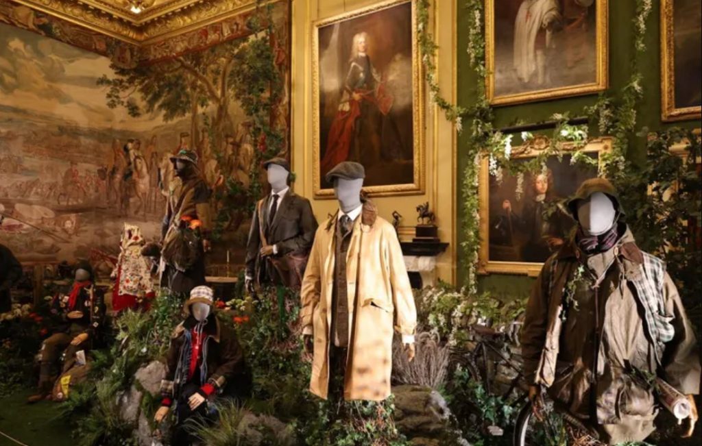 Menswear on display at the palace with brown coats and hats.