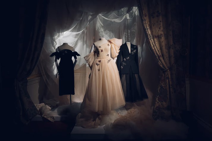 A trio of mannequins wearing white and black dresses.