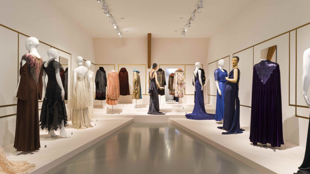 Elegant female mannequins displayed in parallel to each other. Colours signifying evening wear in hues of black, blue, pink and green.