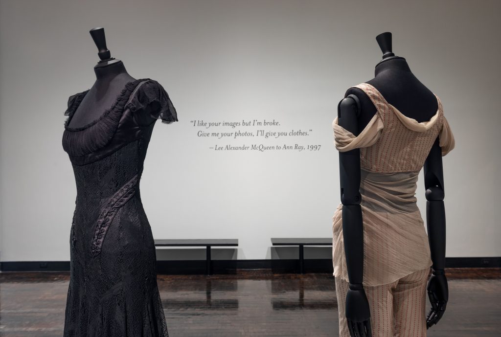 Two female mannequins; left is wearing a lace black dress and the right is wearing a white two piece with red dots.