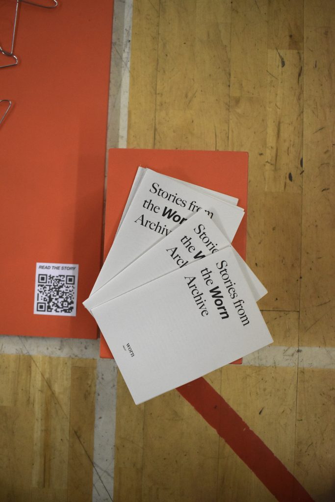 Orange and white cards with exhibition text.