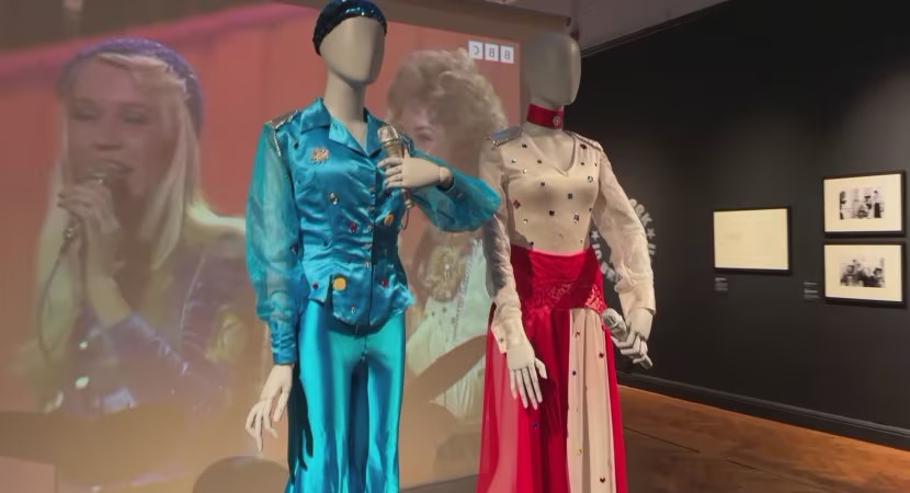 Male and female mannequins wearing a blue shirt and trousers. Female is wearing a white and red, top and skirt.