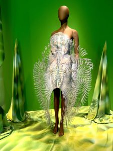White dress shaped like an underwater stingray with white spikey fringing.