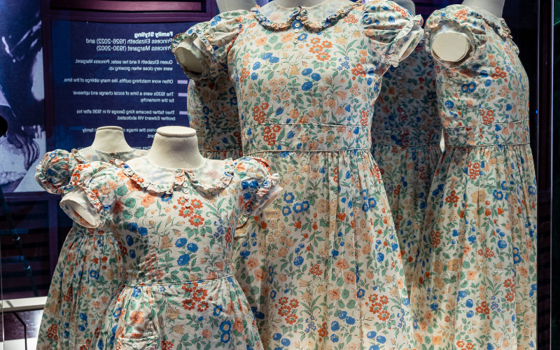 Royal children's floral dresses complete with short sleeves and Peter Pan collar. Dresses are in a red, blue, and green floral print.