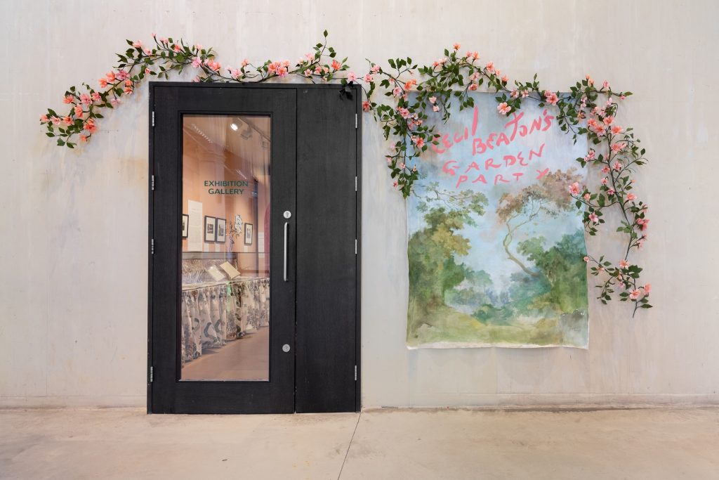 A display of pink floral flowers and a poster.