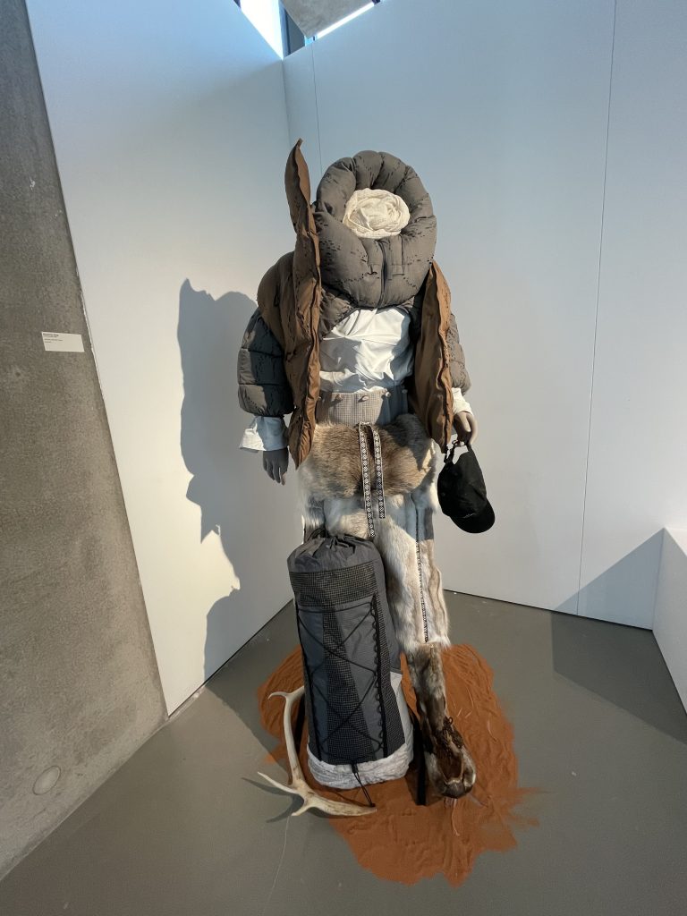 mannequin wearing puffed collar, and winter ensemble