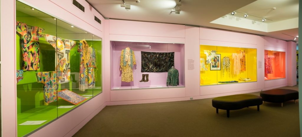 gallery view of colourful walls and garments mounted on walls