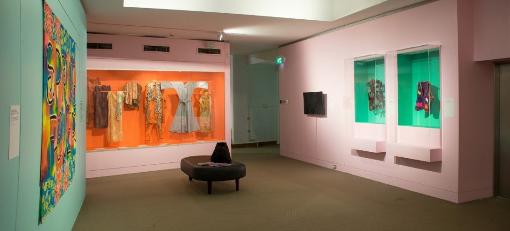 gallery view of colourful walls and garments mounted on walls