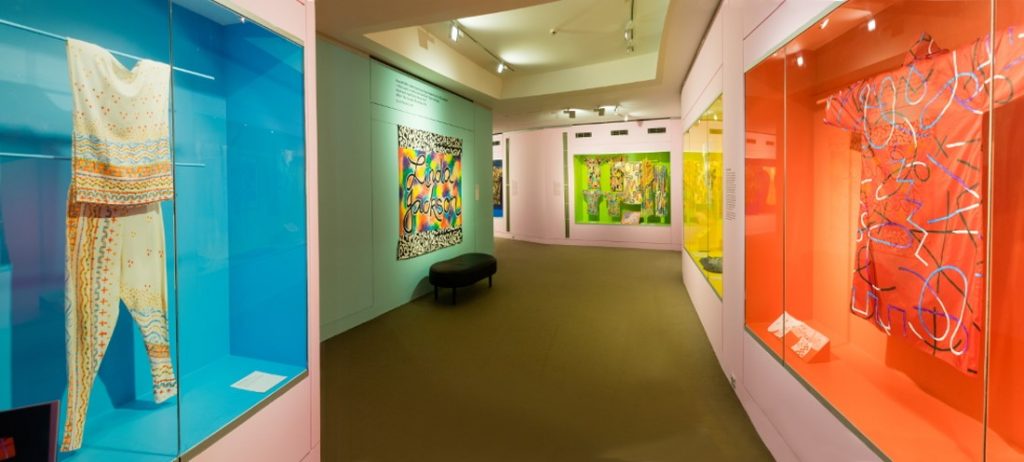 gallery view of colourful walls and garments mounted on walls