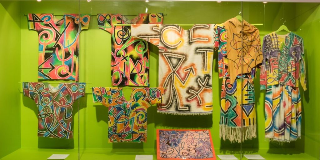 gallery view of colourful walls and garments mounted on walls