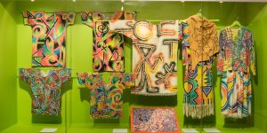 gallery view of colourful walls and garments mounted on walls