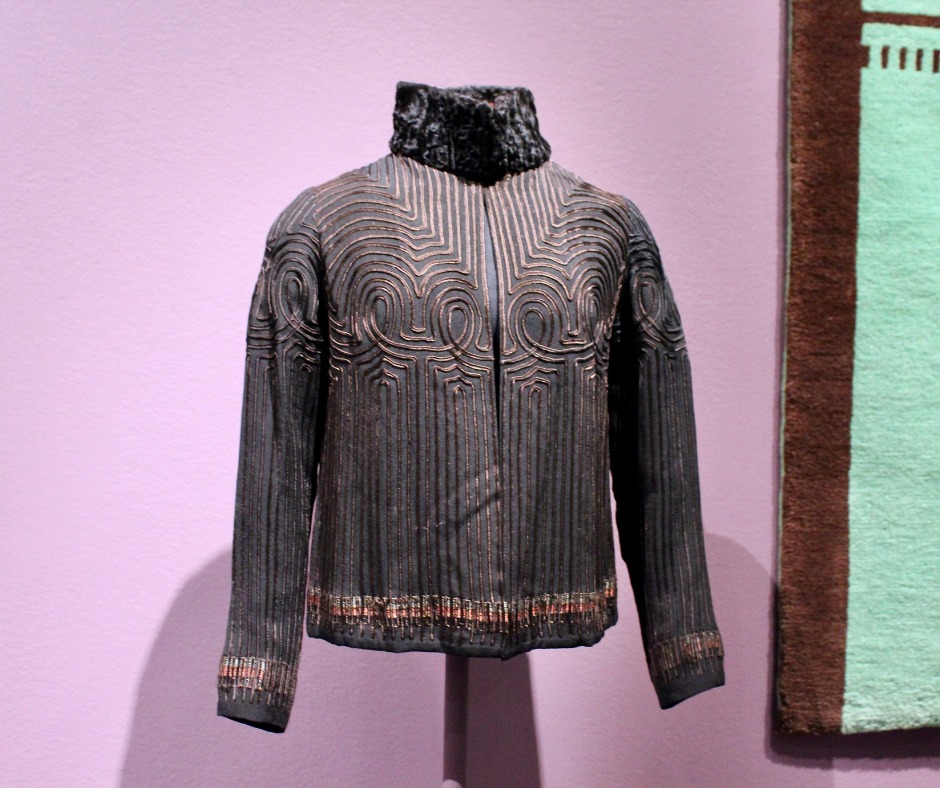 A brown jacket with etchings design on the front.