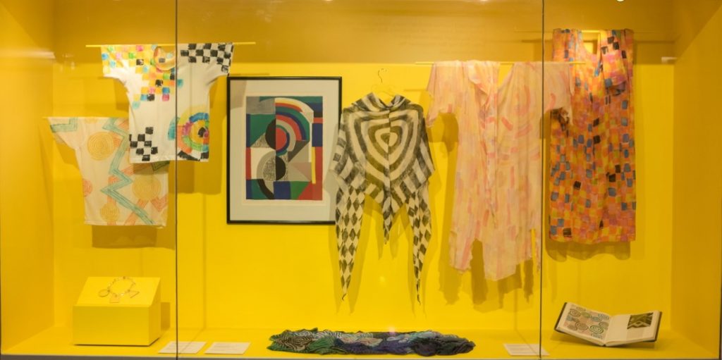 gallery view of colourful walls and garments mounted on walls