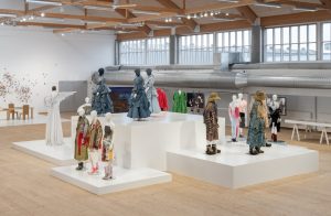 A collection of recycled outfits in hues of brown, yellow, pink, blue, white.