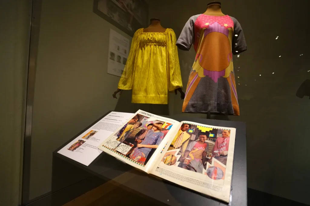 A yellow long sleeve dress with a short sleeve pink, brown, black and pink T shirt dress.