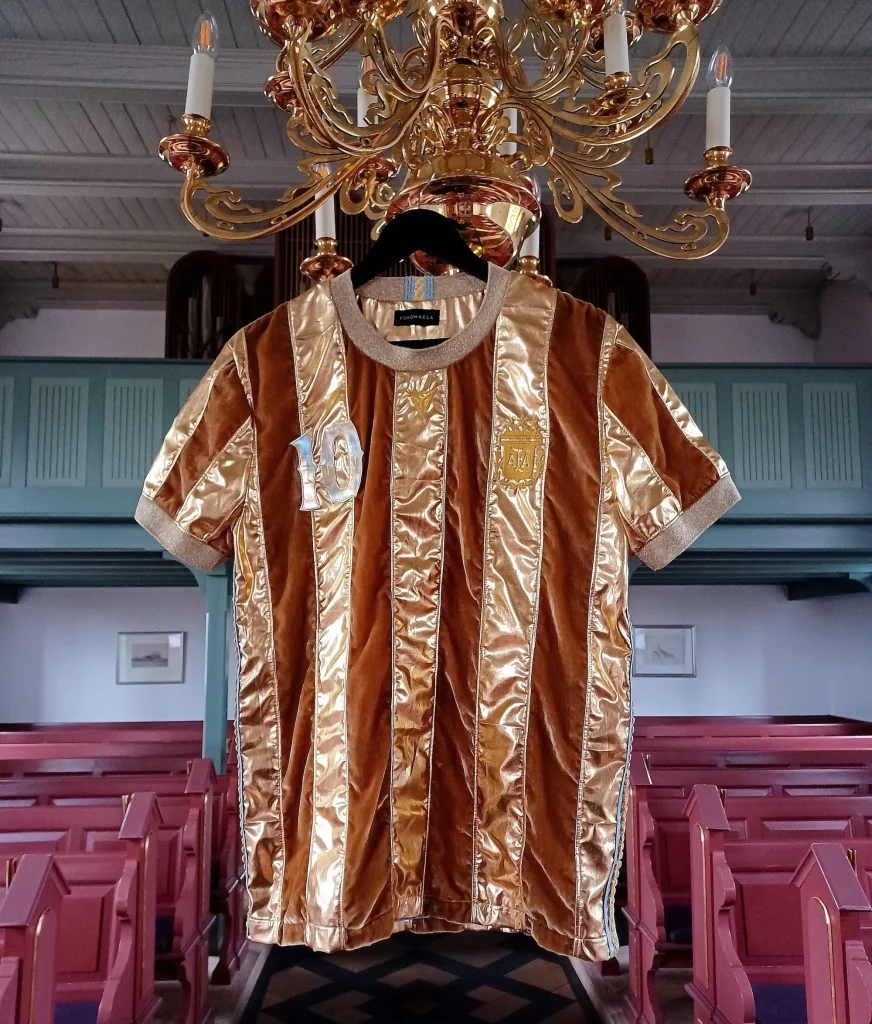 A gold football shirt with brown stripes.