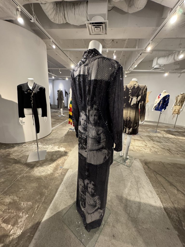 Black printed dress with white and sheer sleeves.