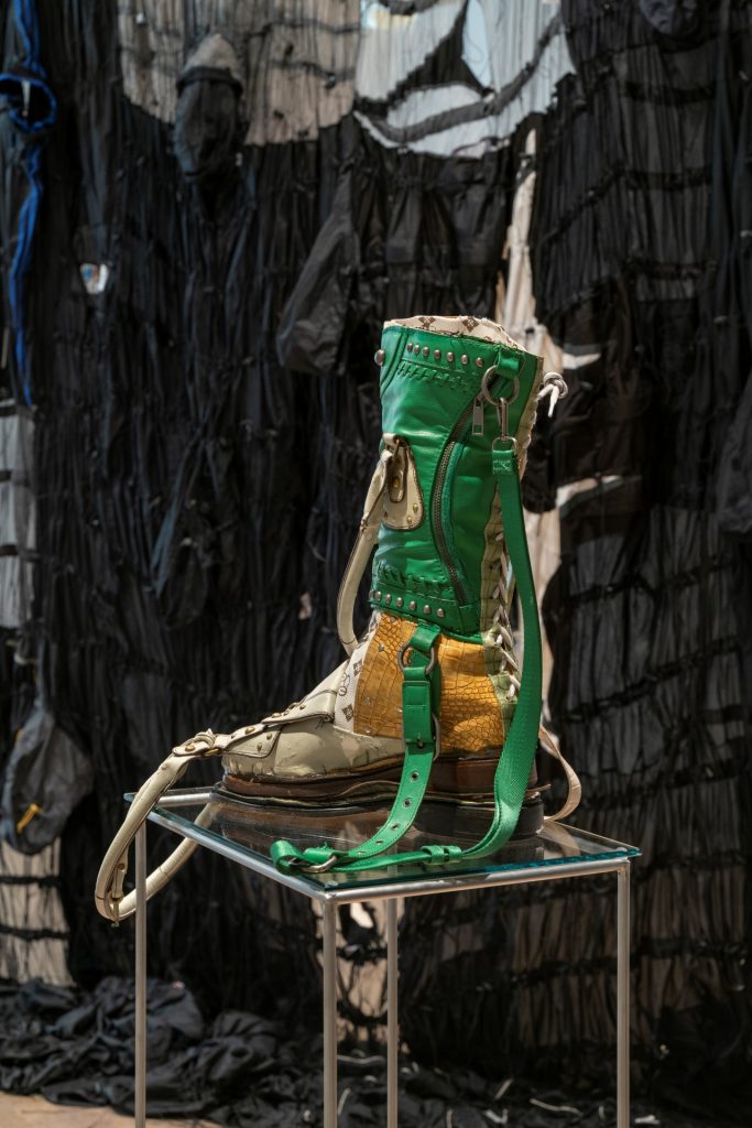 A green and yellow tall boot on display.