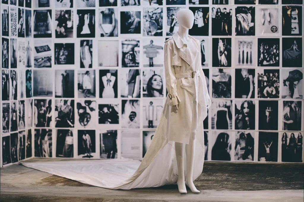 Long white dress with train, dress is shaped as a suit at the front.