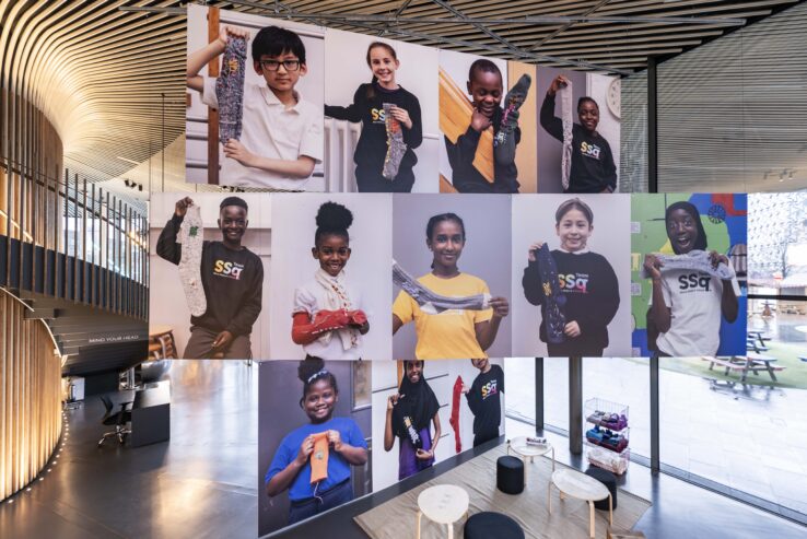 Photography of children holding socks in hues of red, green, white and black.