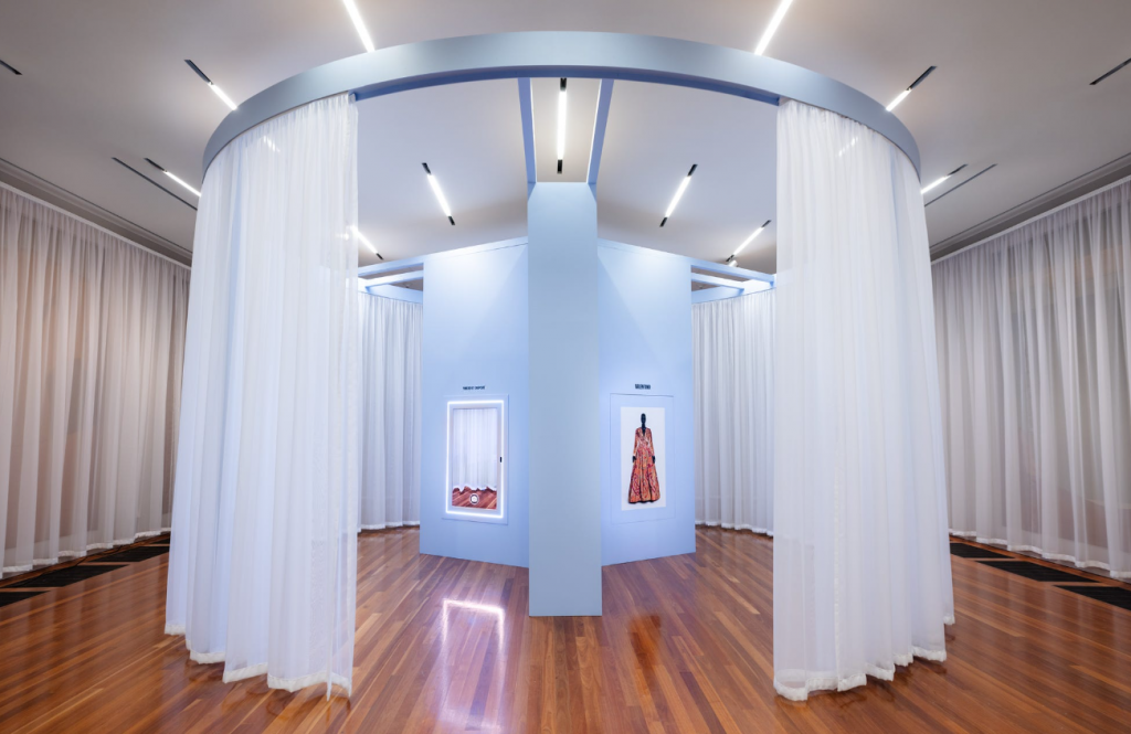 A light up image of an orange dress on display.