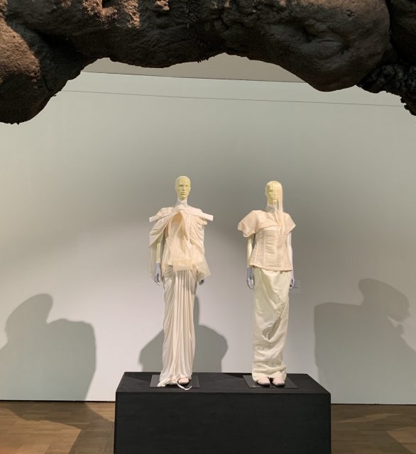 Two mannequins wearing long pink garments.