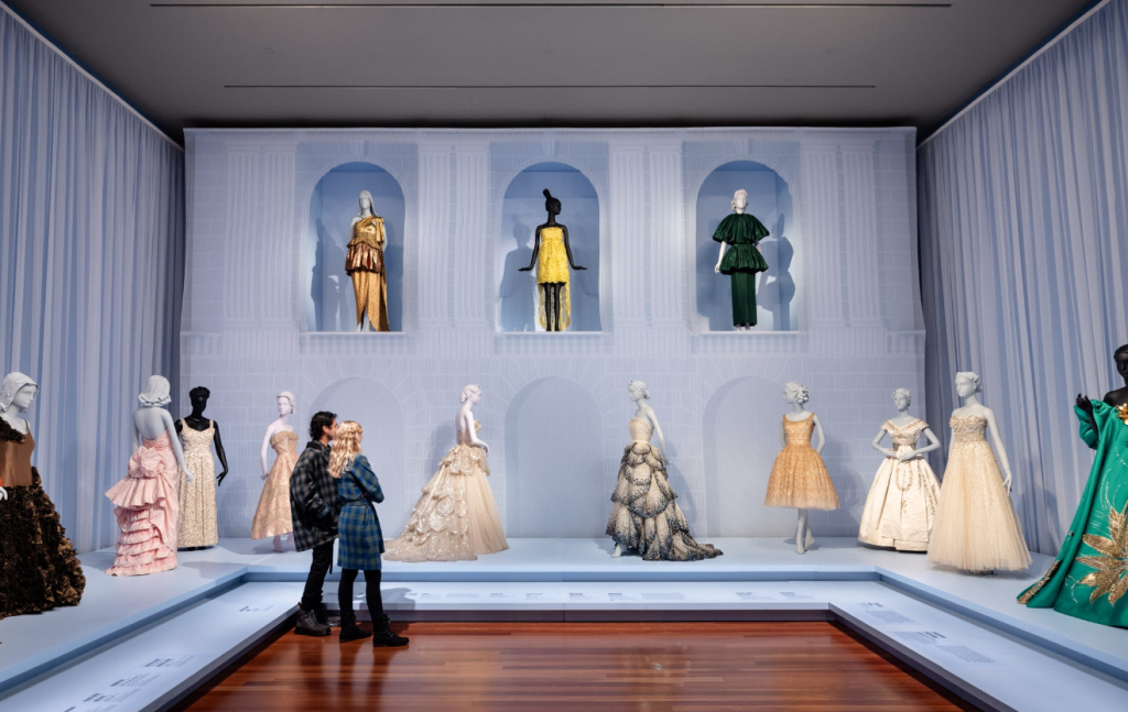 A collection of evening wear and ballgown, in hues of orange, pink, green, white, black and yellow.