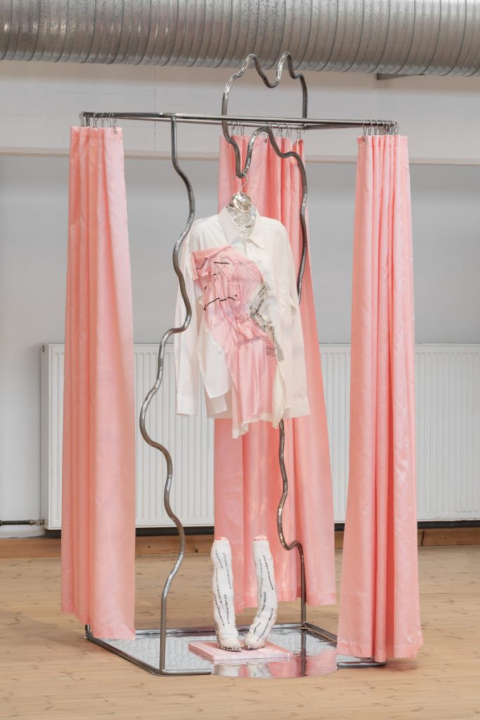 A pink installation with a white and pink outfit.