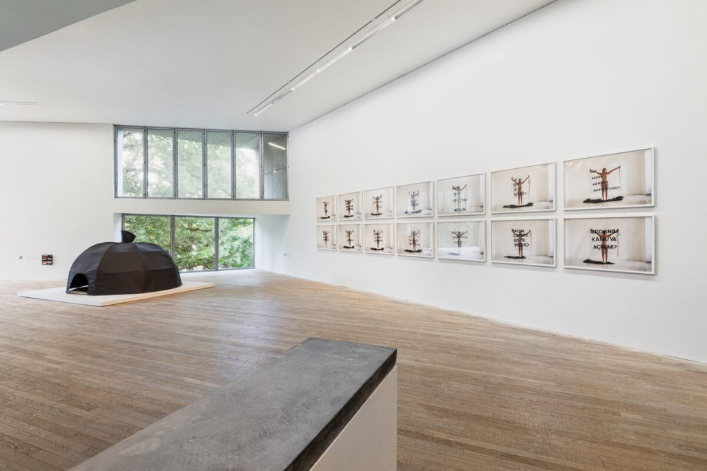 An installation of a black tent with images.